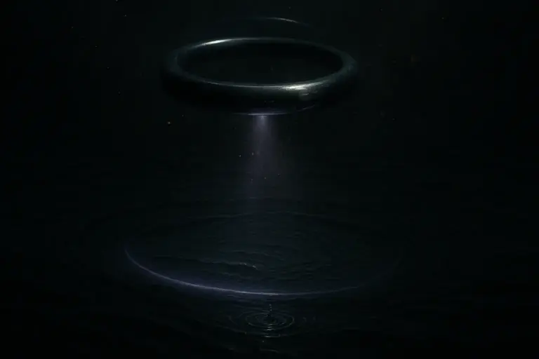Suspended sonar ring emits a violet beam onto black water; ripples below; loch ness monster survey equipment